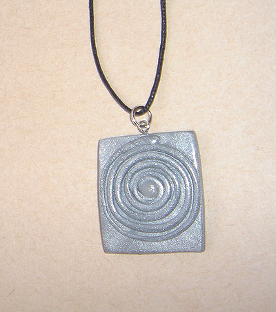 Unique, handmade pendant in the colour of silver sand with a spiral for men.